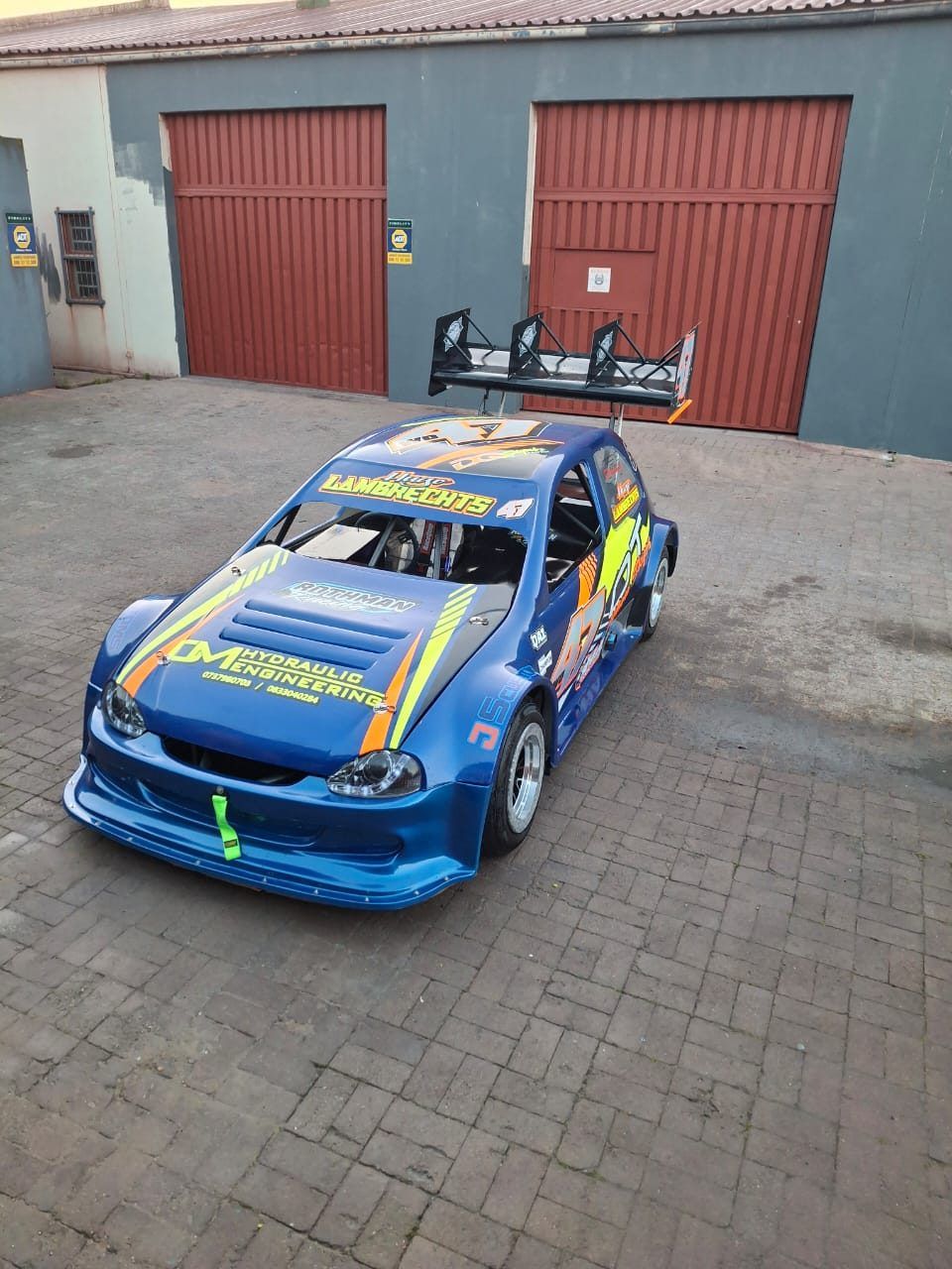 Blue stock car outside the JS Customs workshop