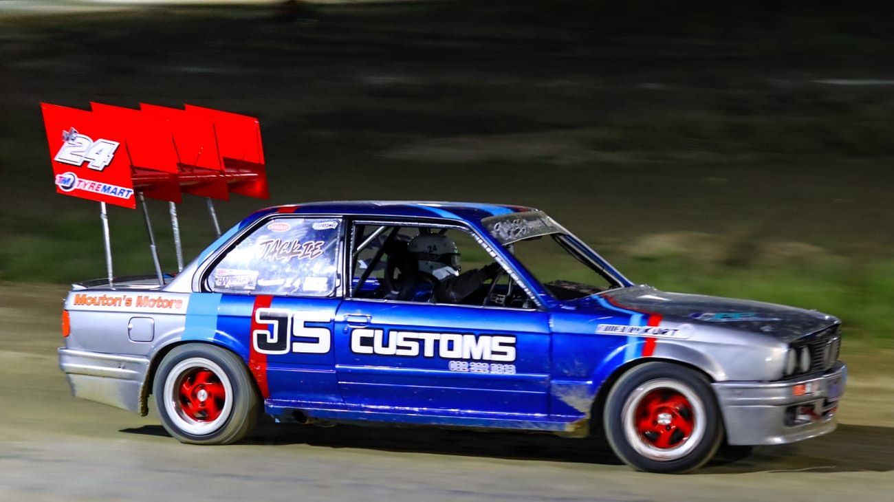 Finished blue and silver JS Customs BMW stock car on track