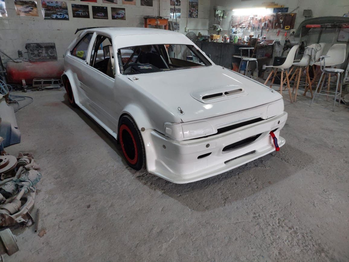 White race car being prepared in the JS Customs workshop